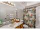 Bathroom featuring a floral shower curtain, mirror, and a well-lit vanity area at 3031 S Los Altos --, Mesa, AZ 85202