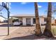 Front exterior showcasing the home's simple desert landscaping and carport at 3031 S Los Altos --, Mesa, AZ 85202