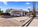 Single story home with a carport and a basketball hoop on the driveway, under a blue sky with white clouds at 3031 S Los Altos --, Mesa, AZ 85202