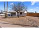 Charming single story house with a gravel yard and a mature tree, under a blue sky with white clouds at 3031 S Los Altos --, Mesa, AZ 85202