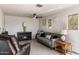 Cozy living room features tile flooring, a ceiling fan, and a decorative fireplace at 3031 S Los Altos --, Mesa, AZ 85202