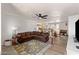 Cozy living room features a brown sectional couch and views into the kitchen, dining, and outdoor patio areas at 3031 S Los Altos --, Mesa, AZ 85202