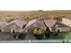 A panoramic view of three single-story homes in a desert community, showcasing their tile roofs at 30816 N 138Th Ave, Peoria, AZ 85383