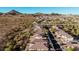 Scenic aerial view of a neighborhood featuring desert landscaping, mountains in the distance, and well-maintained homes at 30816 N 138Th Ave, Peoria, AZ 85383