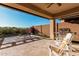 A covered patio features a built-in grill, outdoor seating, and mountain views, perfect for entertaining or relaxing at 30816 N 138Th Ave, Peoria, AZ 85383