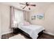 Comfortable bedroom featuring a ceiling fan, natural light, and tasteful décor at 30816 N 138Th Ave, Peoria, AZ 85383