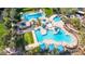 Aerial view of a luxurious community pool featuring multiple pools, lounge areas, and lush landscaping for residents at 30816 N 138Th Ave, Peoria, AZ 85383