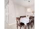 Cozy dining room with a table set for six, neutral paint, tile floors, and soft lighting at 30816 N 138Th Ave, Peoria, AZ 85383