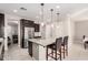 Kitchen island with stainless steel appliances, modern lighting, and granite countertops at 30816 N 138Th Ave, Peoria, AZ 85383