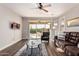 Bright living room with sliding glass doors to backyard, ceiling fan, and comfortable seating at 30816 N 138Th Ave, Peoria, AZ 85383