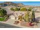 Stunning aerial view of a single-Gathering home with a three car garage, mature landscaping and mountain views at 3144 E Desert Broom Way, Phoenix, AZ 85048