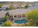 Aerial view of pool, covered patio and backyard with lush landscaping and mountain views at 3144 E Desert Broom Way, Phoenix, AZ 85048