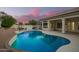 Backyard at dusk featuring a pool and covered patio at 3144 E Desert Broom Way, Phoenix, AZ 85048