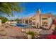 Beautiful backyard featuring a pool, patio, and lush desert landscaping at 3144 E Desert Broom Way, Phoenix, AZ 85048