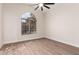 Bedroom with arched window, ceiling fan and tile flooring at 3144 E Desert Broom Way, Phoenix, AZ 85048