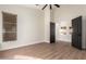 Bedroom with a ceiling fan and natural light; features wood-look tile floors and a large closet at 3144 E Desert Broom Way, Phoenix, AZ 85048