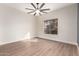 Bedroom features a ceiling fan, a window that provides lots of natural light, and tile flooring at 3144 E Desert Broom Way, Phoenix, AZ 85048