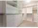 Walk-in closet features custom shelving, drawers and ample storage space at 3144 E Desert Broom Way, Phoenix, AZ 85048