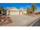 Spacious three-car garage with extended driveway, mature trees, and desert landscaping at 3144 E Desert Broom Way, Phoenix, AZ 85048