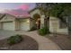 View of entrance features desert landscaping, walkway, covered entry and three car garage at 3144 E Desert Broom Way, Phoenix, AZ 85048