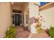 Inviting entryway with a decorative front door and a tiled walkway surrounded by desert plants at 3144 E Desert Broom Way, Phoenix, AZ 85048