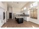 Bright kitchen features stainless steel appliances, black island, white cabinetry, and modern lighting at 3144 E Desert Broom Way, Phoenix, AZ 85048