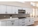 Modern kitchen featuring white cabinets, stainless steel appliances, and tile backsplash at 3144 E Desert Broom Way, Phoenix, AZ 85048