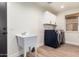 Laundry room with modern washer and dryer, utility sink, and overhead storage at 3144 E Desert Broom Way, Phoenix, AZ 85048