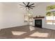 Bright living room featuring a fireplace, large windows, and ceiling fan at 3144 E Desert Broom Way, Phoenix, AZ 85048