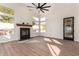 Bright living room showcasing a cozy fireplace, large windows, and a stylish ceiling fan at 3144 E Desert Broom Way, Phoenix, AZ 85048