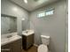 Bathroom with double sink vanity, wood-look vinyl flooring, and modern fixtures in neutral tones at 318 E Hill Dr, Avondale, AZ 85323