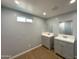 Bathroom featuring wood-look vinyl flooring and double sink vanity with gray cabinets and white countertops at 318 E Hill Dr, Avondale, AZ 85323