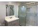 Bathroom featuring marble-look tiling in the shower and a modern gray vanity with sleek fixtures at 318 E Hill Dr, Avondale, AZ 85323