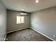 Bright bedroom featuring a window with natural light, neutral walls and plush carpet at 318 E Hill Dr, Avondale, AZ 85323