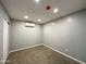 Bedroom with neutral gray walls, plush carpet, and ductless air conditioner for personalized comfort at 318 E Hill Dr, Avondale, AZ 85323