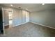 Bright bedroom with neutral walls, plush carpet, and open access to an adjacent room showcasing modern living at 318 E Hill Dr, Avondale, AZ 85323