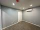 A neutral-toned bedroom featuring plush carpeting, smooth walls, and climate control via a ductless air conditioner at 318 E Hill Dr, Avondale, AZ 85323