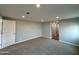 Bedroom with neutral walls and plush carpet, bathed in light from recessed lighting and a hallway entrance at 318 E Hill Dr, Avondale, AZ 85323