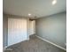 Neutral bedroom showcasing closet doors and carpet flooring with freshly painted walls at 318 E Hill Dr, Avondale, AZ 85323