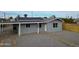 Single story home with gravel yard and a light-colored fence at 318 E Hill Dr, Avondale, AZ 85323