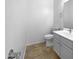 Well-lit half bathroom with a tiled floor, a sink vanity, and a toilet at 3201 W Five Mile Peak Dr, San Tan Valley, AZ 85144