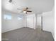 Bare main bedroom featuring plush carpet, neutral tones, a ceiling fan, and ample natural light at 3201 W Five Mile Peak Dr, San Tan Valley, AZ 85144