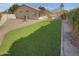 Expansive backyard with artificial grass, perfect for outdoor recreation at 3313 N Lakeshore Ct, Avondale, AZ 85392