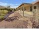 Spacious backyard featuring a covered patio, rock landscaping, and a stone walkway at 3313 N Lakeshore Ct, Avondale, AZ 85392