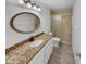 Cozy bathroom featuring stylish vanity, granite countertop, and glass shower at 3313 N Lakeshore Ct, Avondale, AZ 85392