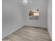 Bright bedroom with wood-look floors, a ceiling fan, and a window view of a neighboring home at 3313 N Lakeshore Ct, Avondale, AZ 85392