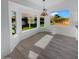 Bright dining area featuring luxury vinyl plank flooring, ample windows, and backyard views at 3313 N Lakeshore Ct, Avondale, AZ 85392