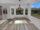 Bright dining nook with luxury vinyl plank flooring, bay windows, and sliding glass doors to patio at 3313 N Lakeshore Ct, Avondale, AZ 85392