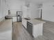 Bright and modern kitchen featuring white cabinets, stainless steel appliances, and a large center island at 3313 N Lakeshore Ct, Avondale, AZ 85392