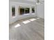 Sunlit living room with bright windows overlooking the private backyard and light colored floors at 3313 N Lakeshore Ct, Avondale, AZ 85392